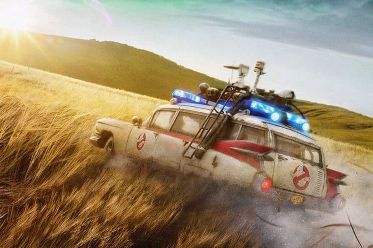A ghostbusters vehicle driving through a field.